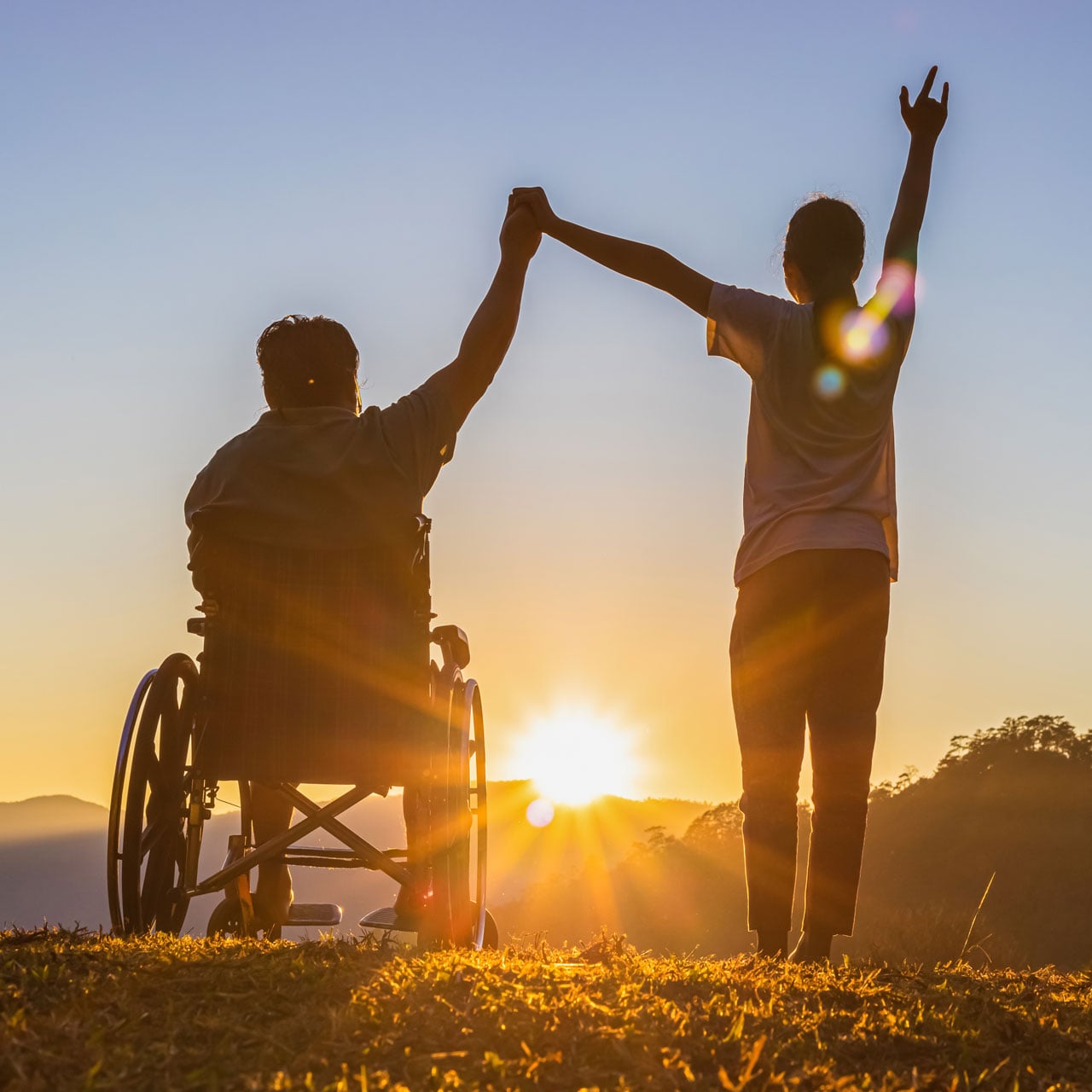 Person in wheelchair at sunrise